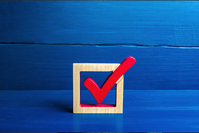 Red voting check mark on a blue background.