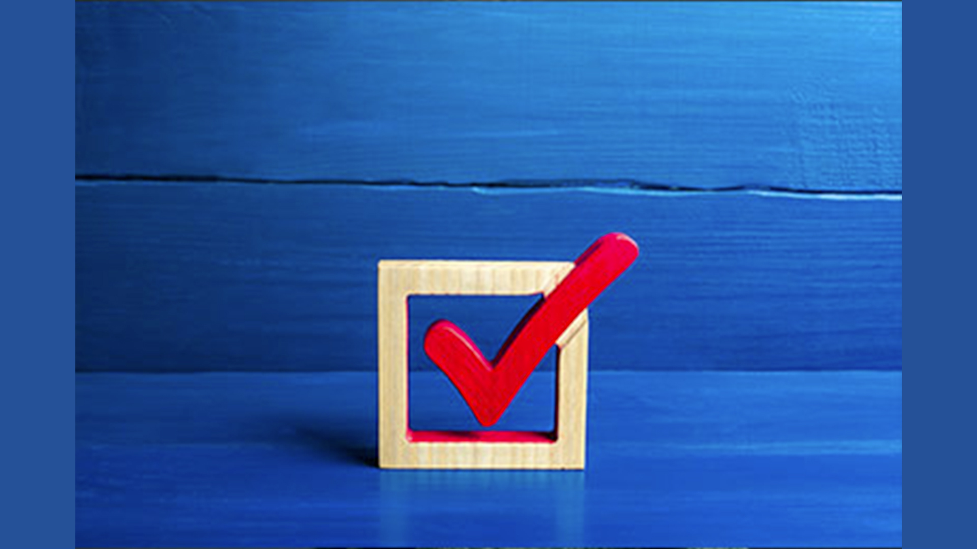 A wooden box with a red checkmark in the middle on a blue background