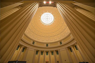 Worm's eye view of pillars meeting a domed ceiling.