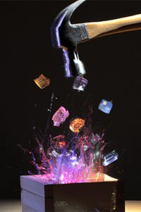 AI generated photo of A hammer hitting a wooden box with shiny crystals flying up as sparks